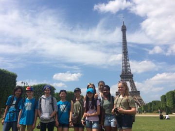 students pose in front of the Eiffel tower