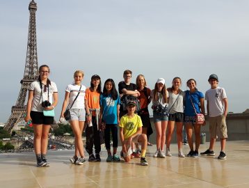 School group poses with the Eiffel tower in the background