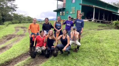 A group of students holding shovels.
