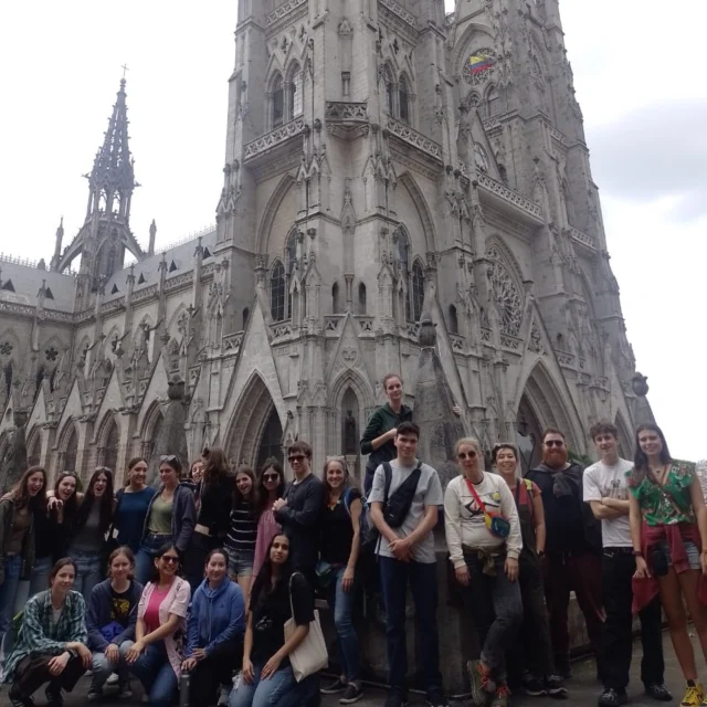 A group of students in front of a large historical building.