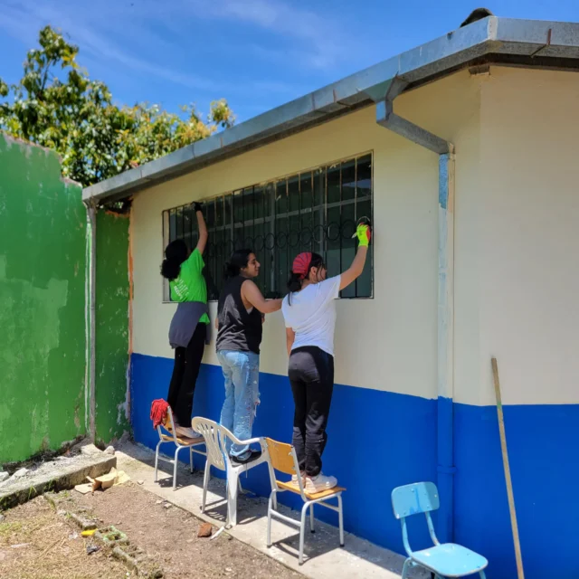 Students painting a wall.