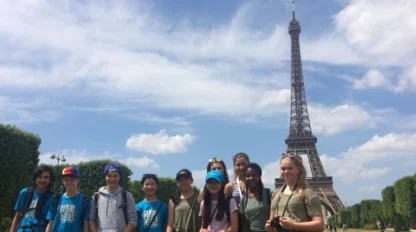 students pose in front of the Eiffel tower