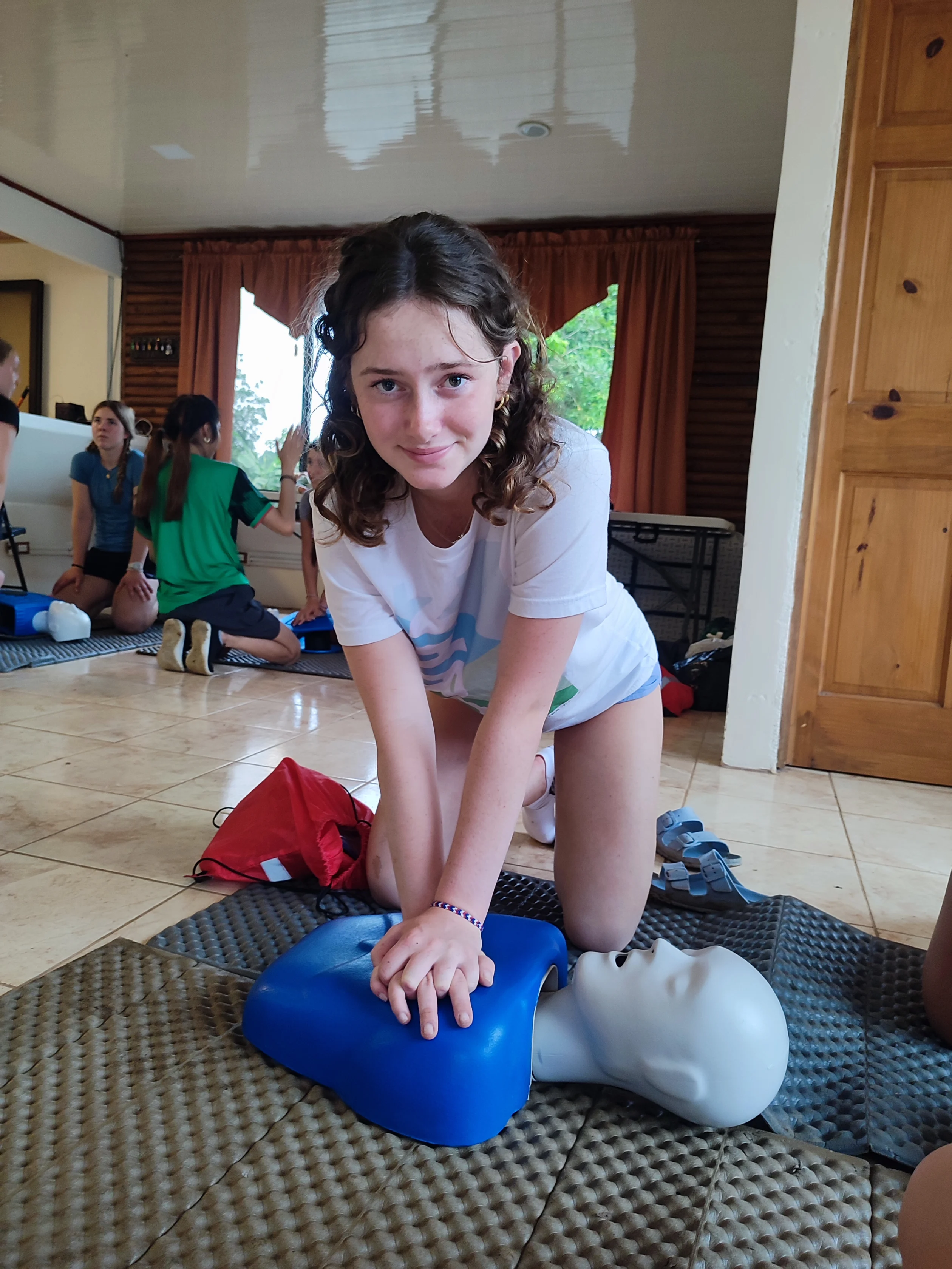 A student practices CPR on a training mannequin during a Global Works pre-med and public health program in Costa Rica.