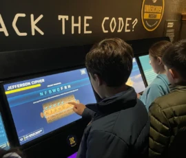 Visitors interact with a touchscreen exhibit about the Jefferson Cipher, solving a code as part of an "Undercover Mission" activity.
